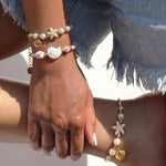 Rope bracelet with shell and floral design beads
