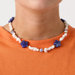 Necklace with stone beads, white beads with blue flowers and statement flowers