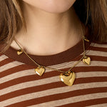 Necklace with beads and different shaped hearts