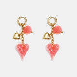 Earrings with dangling hearts on a chain