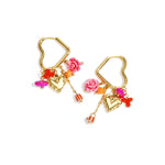 Heart-shaped hoop earrings with beaded pendants and charms