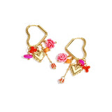 Heart-shaped hoop earrings with beaded pendants and charms