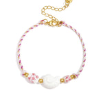 Rope bracelet with shell and floral design beads