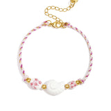 Rope bracelet with shell and floral design beads